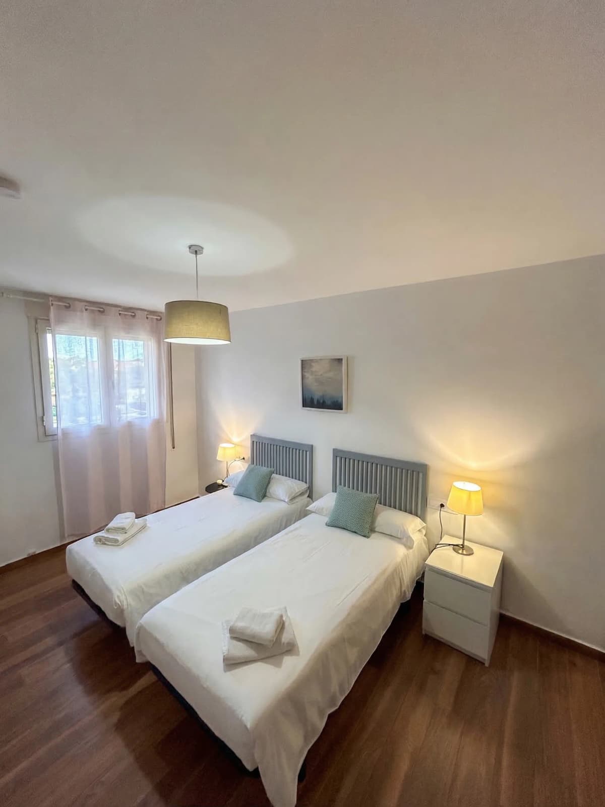 Cozy twin bedroom with soft lighting