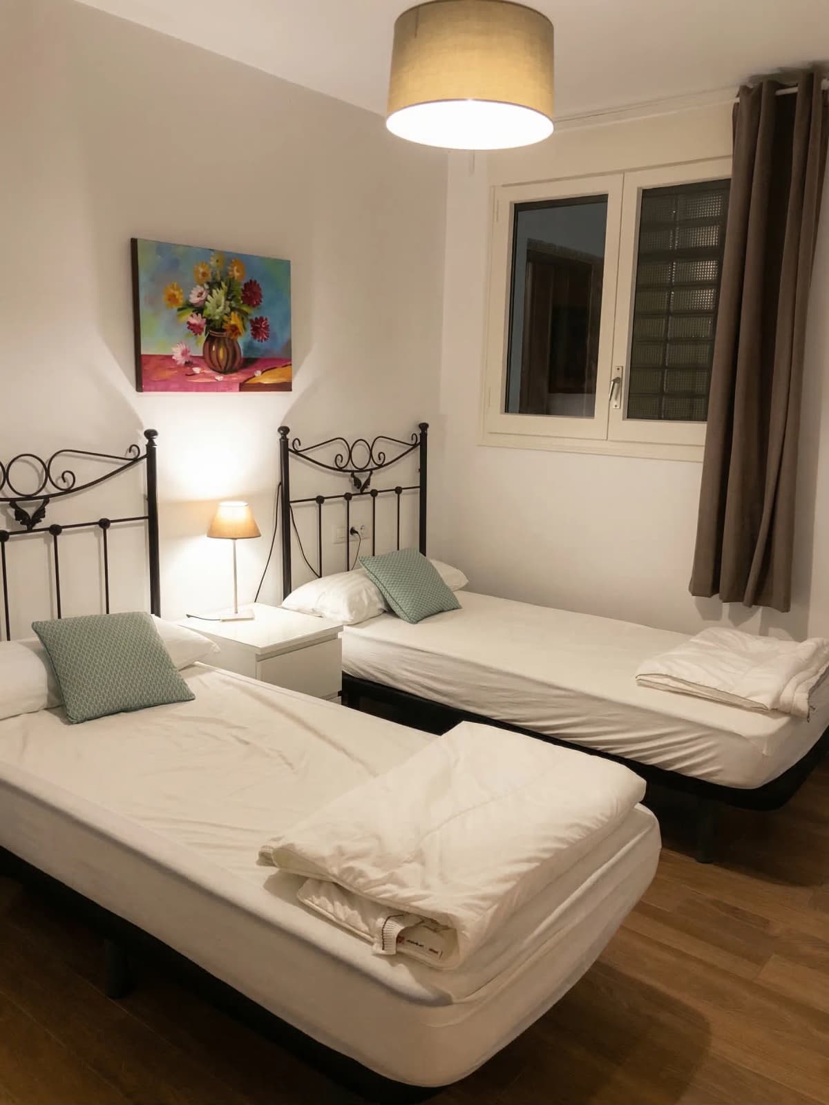 Twin room with ornate iron beds