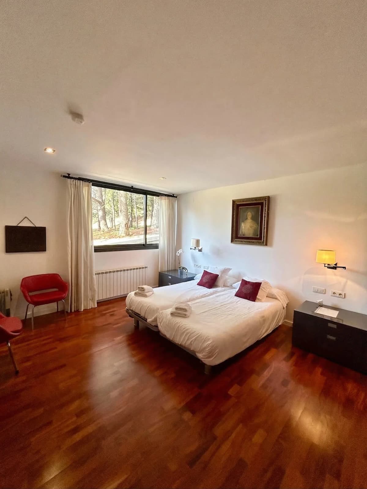 Spacious master bedroom with cherry floors